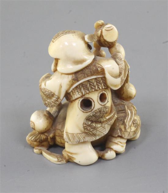 An ivory netsuke of Daikoku and two boys, Meiji period, height 4cm